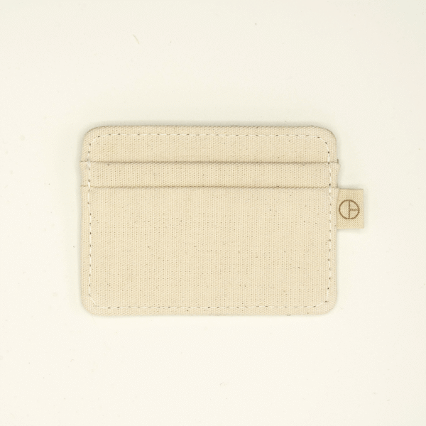 Back view of a natural undyed cotton cardholder with stitched edges and a subtle side tag showing the CARDHΞ↓R symbol.