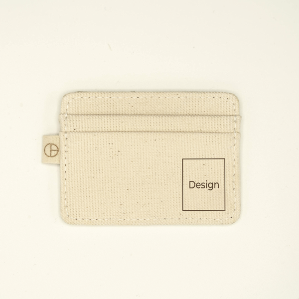 Natural canvas cardholder with a custom laser-engraving area marked “Design” on the front. Features side tab with logo and double card slots.