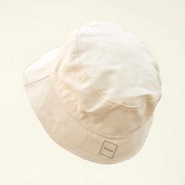 Undyed canvas bucket hat with minimalist square laser engraving labeled “Design” placed discreetly on the lower back panel. Part of CARDHΞ↓R’s Variable Custom Edition series.