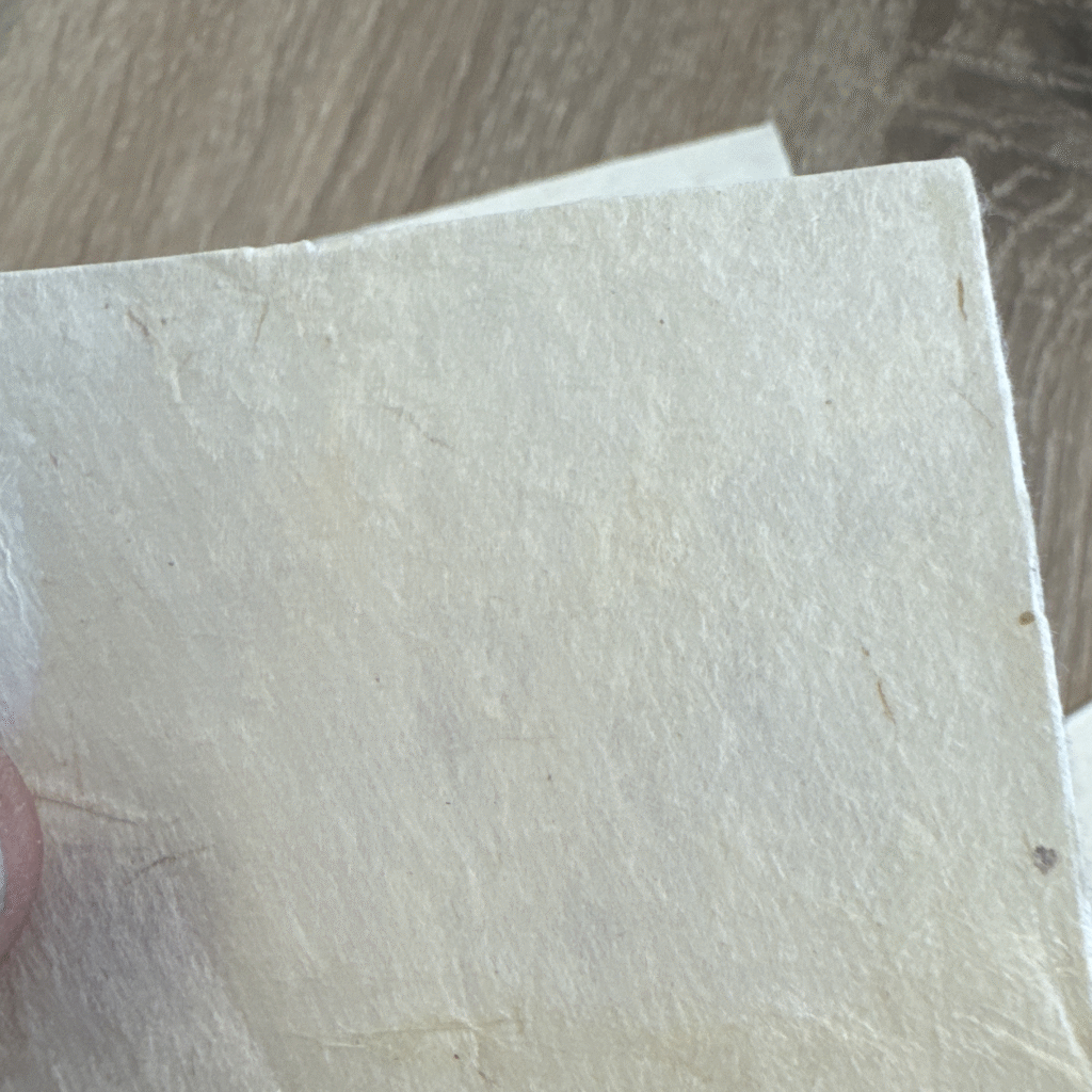 Close-up of handmade textured paper selected in Amsterdam for the original CARDHEIR certificate design
