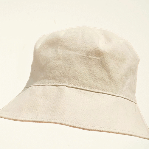 Minimalist bucket hat made from undyed natural cotton, part of CARDHΞ↓R Raw Collection with no visible branding.