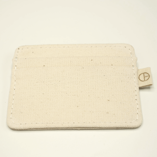Minimalist undyed cotton cardholder with no visible branding, part of the CARDHΞ↓R Raw Collection.