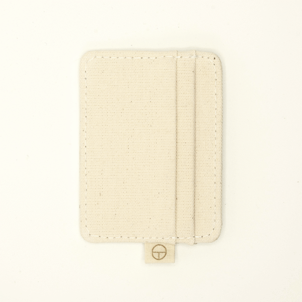 Vertical back view of a minimalist cardholder made from natural undyed cotton, featuring a centered label tab with the CARDHΞ↓R logo.